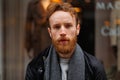 Portrait of a stylish bearded man against the background of elegant clothing store window. Royalty Free Stock Photo