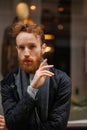 Portrait of a stylish bearded man against the background of elegant clothing store window. Royalty Free Stock Photo