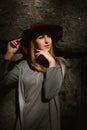 Portrait of stylish blonde model wearing grey warm dress and red Royalty Free Stock Photo