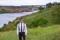 Portrait of stylish brunet young man, wearing white shirt, black tie, suspenders and sunglasses Royalty Free Stock Photo