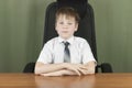 Young business boy. Little boss in office. Funny kids