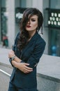 Portrait of a stylish fashionable brunette in a blue suit in the city. Fashion photo Royalty Free Stock Photo