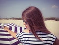 Portrait of a stylish girl in a striped t-shirt and sunglasses b Royalty Free Stock Photo