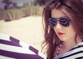 Portrait of a stylish girl in a striped t-shirt and sunglasses Royalty Free Stock Photo