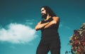 Portrait of stylish handsome young man. Fashion guy. Male model with crossed arms long hair beard, mustache and trendy Royalty Free Stock Photo