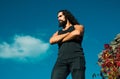 Portrait of stylish handsome young man. Fashion guy. Male model with crossed arms long hair beard, mustache and trendy Royalty Free Stock Photo