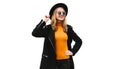 Portrait of stylish happy smiling young woman, female model posing wearing black coat, round hat isolated on white background Royalty Free Stock Photo