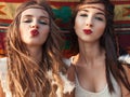 Portrait of Stylish hippie girls having fun and send kiss over e