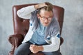 Portrait of a stylish intelligent man with glasses stares into the camera, good view, small unshaven, charismatic, blue shirt, gra Royalty Free Stock Photo