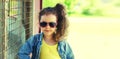 Portrait of stylish little girl child posing wearing jeans jacket in the city Royalty Free Stock Photo