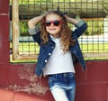 Portrait stylish little girl child wearing a jeans clothes posing in the city Royalty Free Stock Photo