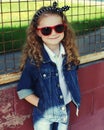 Portrait stylish little girl child wearing a jeans clothes posing in the city Royalty Free Stock Photo