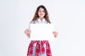 Portrait of a stylish long-haired curly teen girl holding a white A3 horizontal card in her hands on a white background