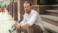 Portrait of young man with beard posing on stone staris at sunset Royalty Free Stock Photo