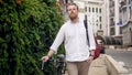 Portrait of stylish man walking to work with bicycle Royalty Free Stock Photo