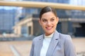 Portrait of stylish smiling business woman in fashionable clothes in the big city purposefully looking away Royalty Free Stock Photo