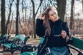 Portrait of stylish woman wearing fur coat holding sunglasses handbag. Autumn clothes and accessories Royalty Free Stock Photo