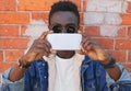 Portrait of stylish young african american man stretching his hands for taking selfie by smartphone on a city street Royalty Free Stock Photo