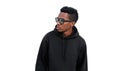 Portrait stylish young african man posing looking away wearing a black hoodie, sunglasses isolated on white background Royalty Free Stock Photo