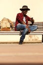Stylish young african man sitting on bench using smart phone Royalty Free Stock Photo