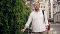 Portrait of stylish male student walking with bicycle Royalty Free Stock Photo