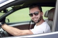 Stylish young man driving a convertible car Royalty Free Stock Photo