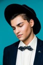 Portrait of a stylish young man in hat wearing elegant suit. Royalty Free Stock Photo