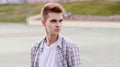 Portrait of stylish young man model looking away on city street Royalty Free Stock Photo