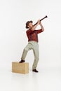 Portrait of stylish young man in red checkered shirt and hat playing clarinet isolated over white background Royalty Free Stock Photo