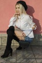 Portrait of stylish young woman in white shirt and knee high boots Royalty Free Stock Photo