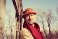 Portrait of a stylishly dressed, bearded man in funny hat