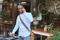 Smiling man standing with a bike talking on a cellphone Royalty Free Stock Photo