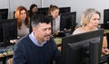 Succesful businessman foreground in busy open plan office Royalty Free Stock Photo