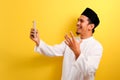 Portrait of Success Young Asian Muslim man happy with winning gesture