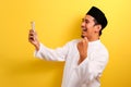 Portrait of Success Young Asian Muslim man happy with winning gesture