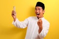 Portrait of Success Young Asian Muslim man happy with winning gesture