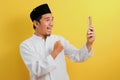 Portrait of Success Young Asian Muslim man happy with winning gesture