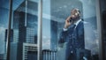 Portrait of Successful African-American Businessman Standing in Office, Making Phone Call to Close Royalty Free Stock Photo