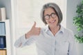 Portrait of successful aged lady company owner hand finger demonstrate thumb up approve feedback office indoors