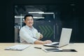 Portrait of successful asian boss, man with cup of hot drink working in modern office, smiling and looking at camera Royalty Free Stock Photo