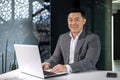 Portrait of successful asian businessman financier, man smiling and looking at camera, boss in business suit working Royalty Free Stock Photo