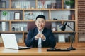 Portrait of a successful Asian businessman, man working in the office sitting at the table, looking at the camera and smiling, Royalty Free Stock Photo