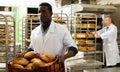 Portrait of successful baker during daily work in bakeshop