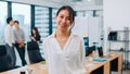 Portrait of successful beautiful executive businesswoman smart casual wear looking at camera and smiling in modern office Royalty Free Stock Photo