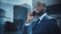 Portrait of Successful Black Businessman Standing in Office, Making a Phone Call to Close the Deal Royalty Free Stock Photo