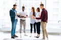 Portrait of successful business team of happy multi-ethnic businesspeople holding Bengal lights and glasses of champagne Royalty Free Stock Photo