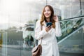 Portrait successful business woman smiling holding smartphone use application chat online in morning Royalty Free Stock Photo