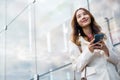 Portrait successful business woman smiling holding smartphone use application chat online in morning Royalty Free Stock Photo