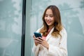 Portrait successful business woman smiling holding smartphone use application chat online in morning Royalty Free Stock Photo