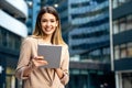 Portrait of a successful business woman using digital tablet in front of modern business building Royalty Free Stock Photo